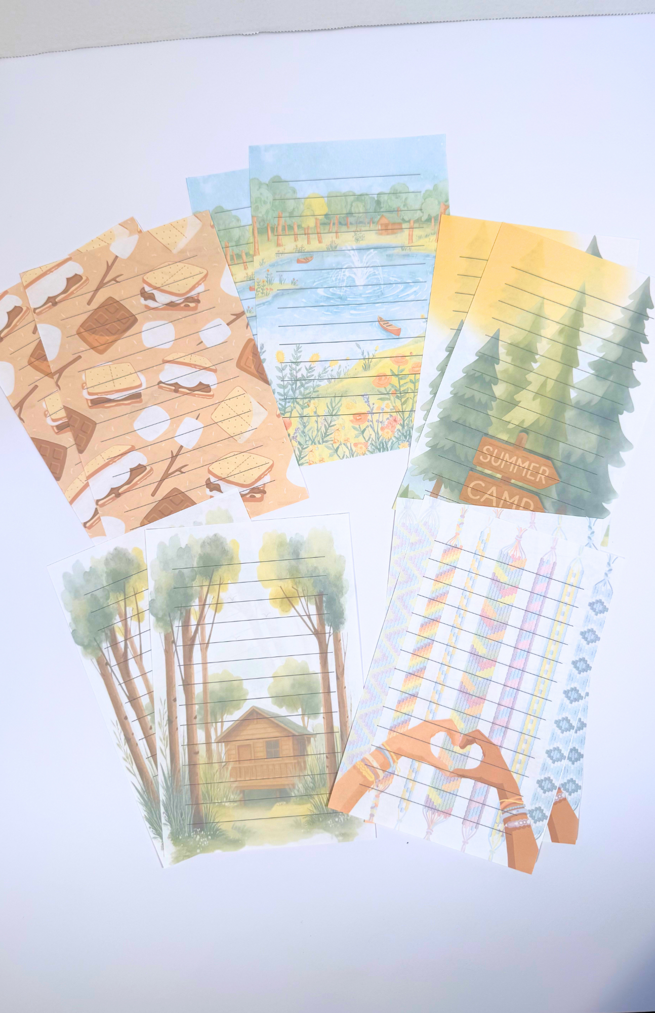 Summer Camp stationery set with woods, cabin, s'more, friendship bracelet, lake, and canoe themes